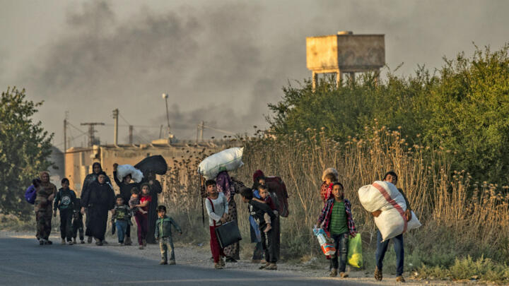 Civilians flee with their belongings amid Turkish bombardment on Syria's northeastern town of Ras al-Ain in the Hasakeh province along the Turkish border on October 9, 2019.
